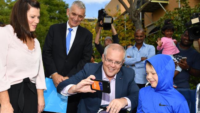 PScott Morrison and wife Jenny talk about the PM’s love of Cronulla Sharks with Shaun Johnson, aged 12, who suffers from leukaemia. Picture: AAP 