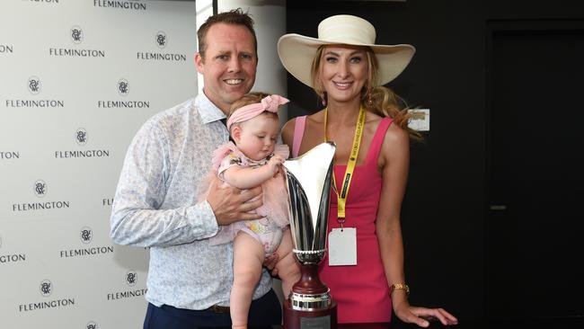 Travis Doudle and wife Emmah with daughter Willow, celebrate a win at Flemington in 2023. Picture: Racing Photos via Getty Images