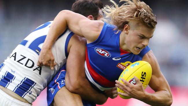 Bulldogs youngster Bailey Smith is brought down by Todd Goldstein. Picture: Michael Klein