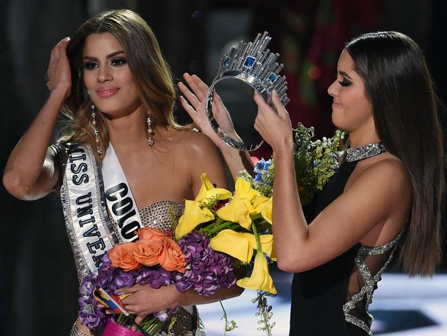 Stripped of the crown ... Miss Universe 2014 Paulina Vega removes the crown from Miss Colombia 2015, Ariadna Gutierrez, in order to give it to Miss Philippines 2015, Pia Alonzo Wurtzbach. Picture: Getty