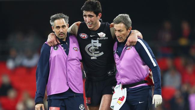 Jacob Weitering needed to be helped from the field after copping a knock to his leg. Picture: Getty