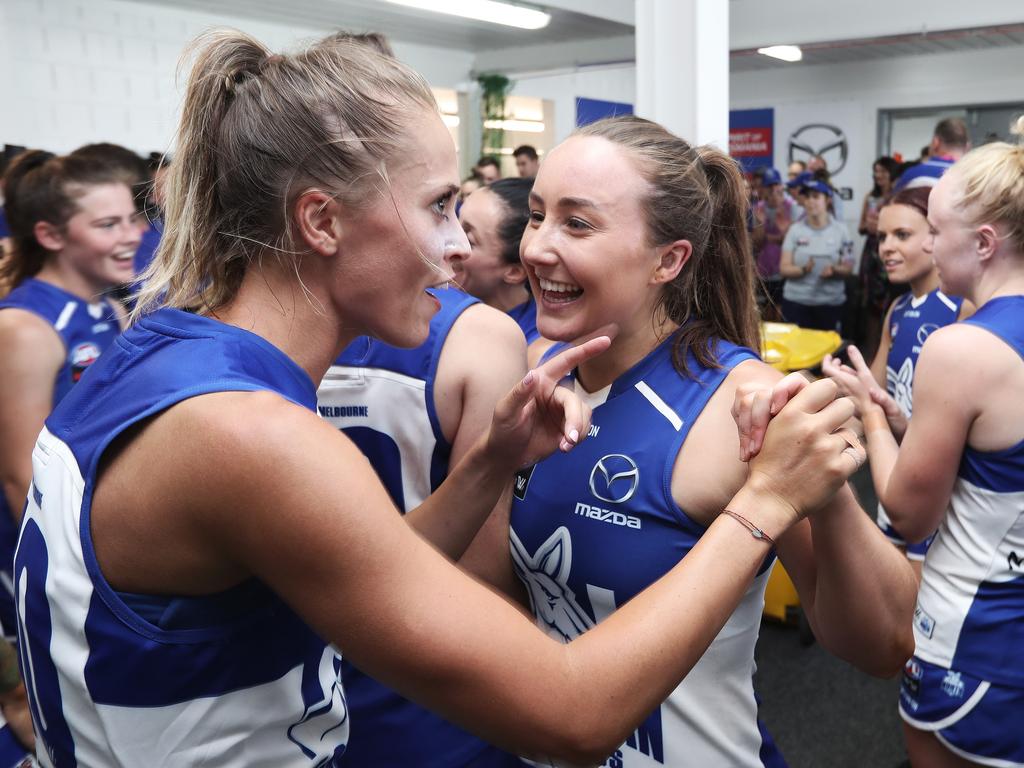 Tasmanian North Melbourne player Nicole Bresnehan, right, celebrates winning the team’s first match with team-mate Kaitlyn Ashmore. Picture: LUKE BOWDEN