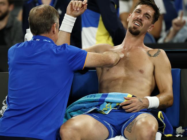 MELBOURNE, AUSTRALIA - JANUARY 15: Thanasi Kokkinakis of Australia receives treatment on his shoulder during a medical time-out in the Men's Singles Second Round match against Jack Draper of Great Britain during day four of the 2025 Australian Open at Melbourne Park on January 15, 2025 in Melbourne, Australia. (Photo by Daniel Pockett/Getty Images)