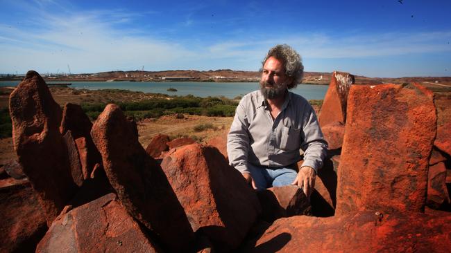 Archaeologist Ken Mulvaney with The Standing Stones above Kings Bay, close to port facilities on the Burrup Peninsula near Dampier, WA.