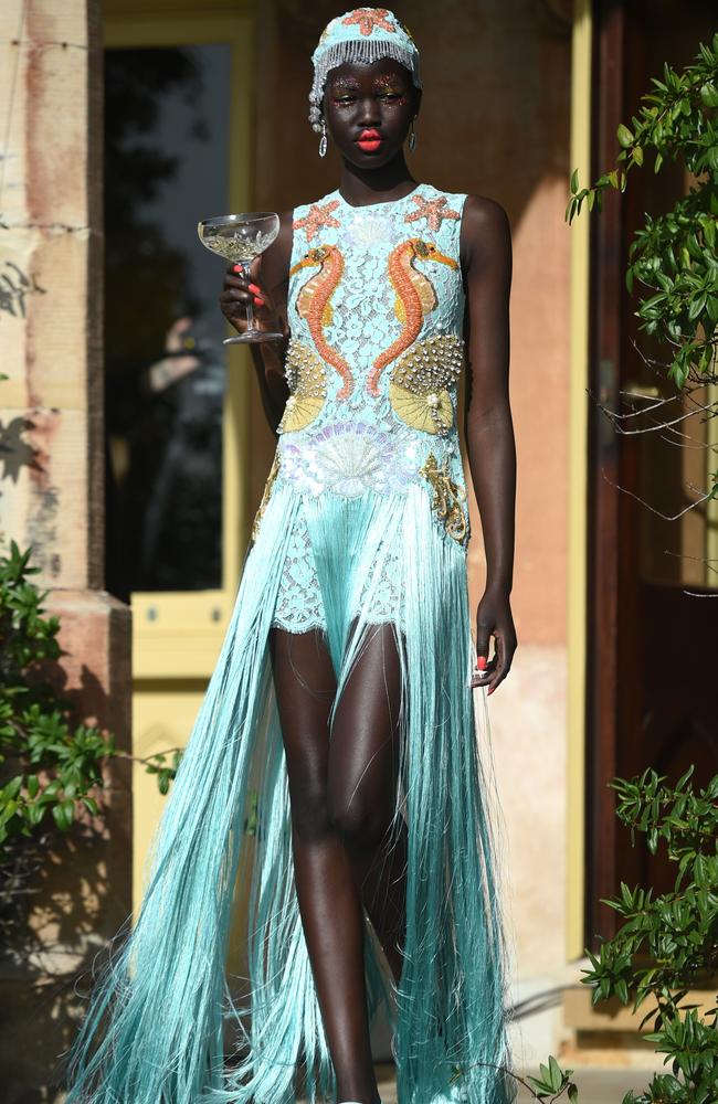 A model poses in a creation from Australian fashion company Romance Was Born during their show for Fashion Week Australia at the historic Carthona House in Sydney on May 18, 2016. / AFP PHOTO / PETER PARKS