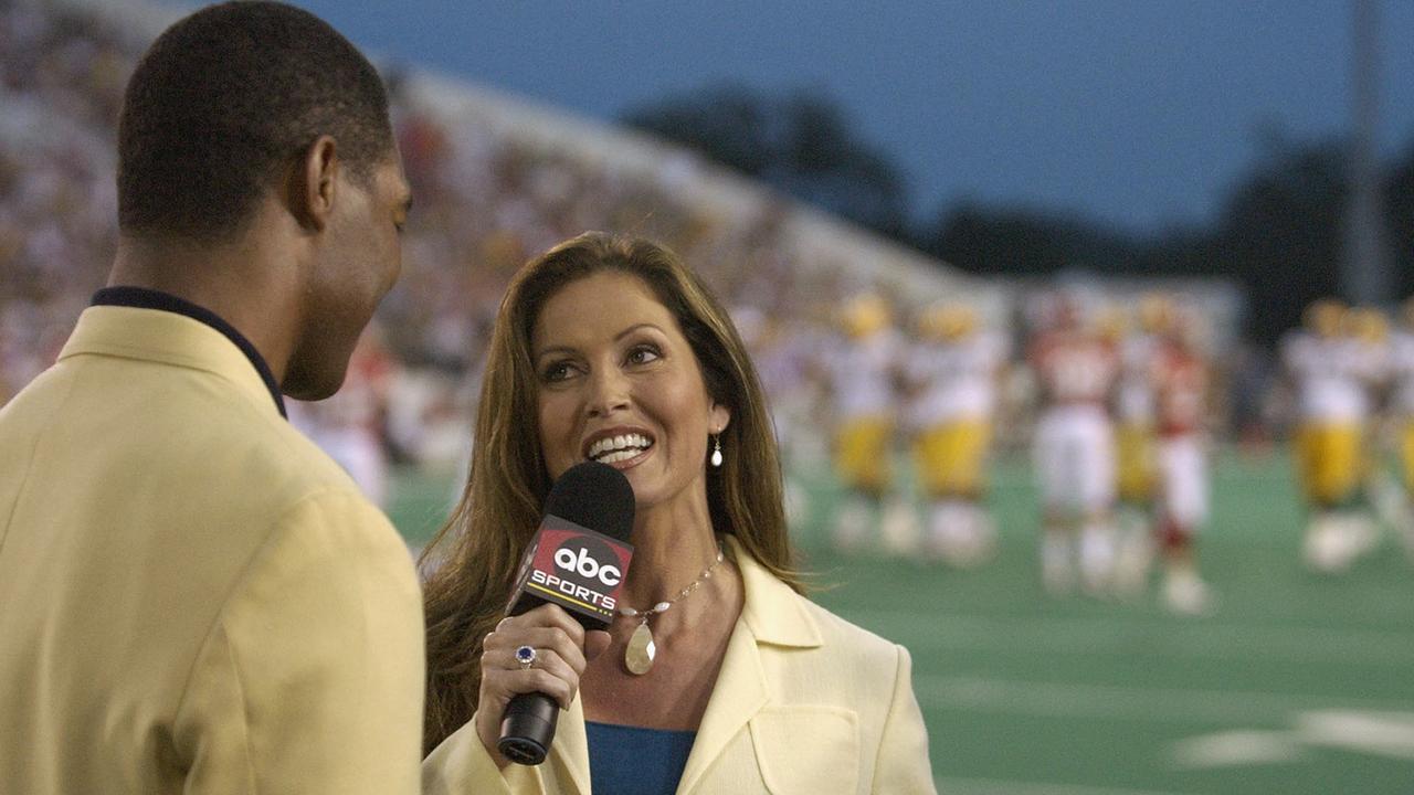 ABC's Monday Night Football sideline reporter Lisa Guerrero interviews Pro Football Hall of Fame enshrinee Marcus Allen. (Photo by David Maxwell/Getty Images)