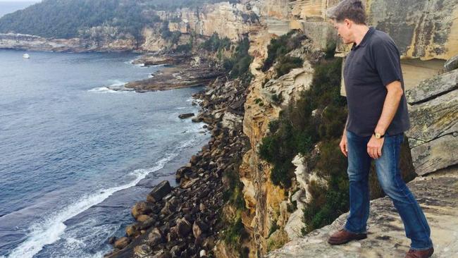 Steve Johnson looks over the cliffs at North Head in Manly in 2016, where his brother Scott's body was found in 1988.