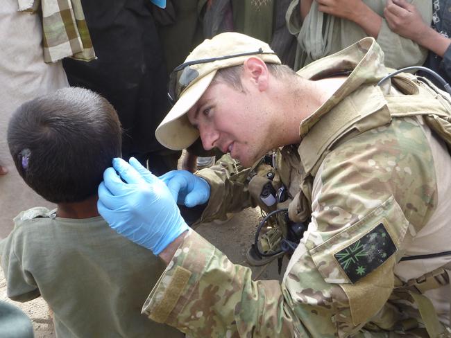 Voodoo Medic Tom Newkirk treats a little boy. Picture: Supplied