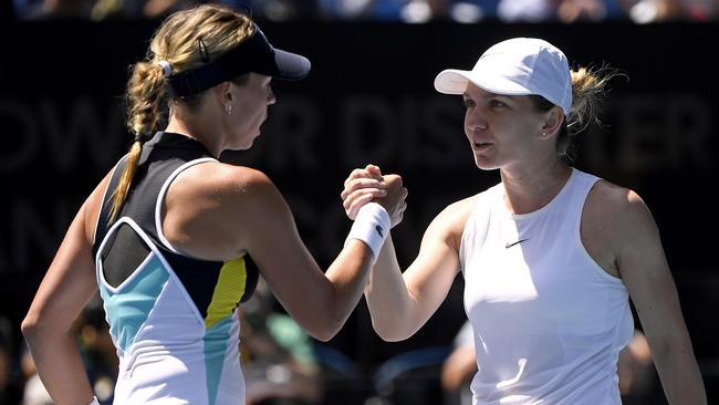 Kontaveit and Halep meet in the middle of the court after their quarterfinal clash. Picture: AP