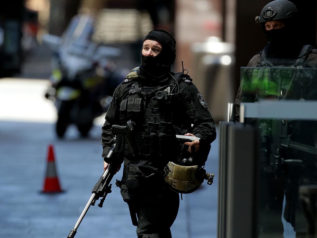 Armed police move into position early in the siege. Picture: Getty Images