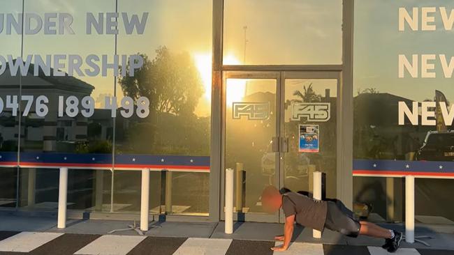 A customer does a push up outside F45 Runaway Bay, the Gold Coast, which has also shut.