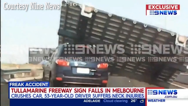 The moment a car is crushed by a freeway sign