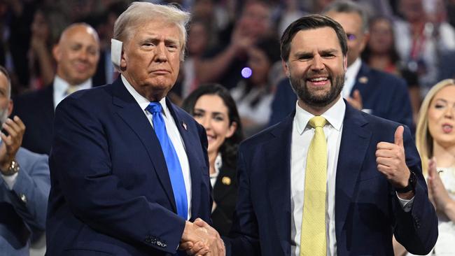 J.D. Vance (R) gives a thumbs up as he shakes hands with US former President and 2024 Republican presidential candidate Donald Trump during the second day of the 2024 Republican National Convention.