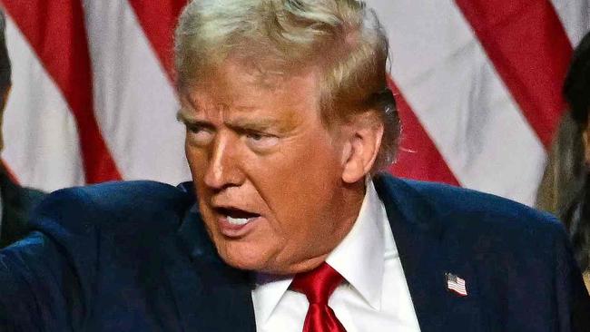 Former US President and Republican presidential candidate Donald Trump gestures at supporters after speaking as he holds hands with former US First Lady Melania Trump during an election night event at the West Palm Beach Convention Center in West Palm Beach, Florida, early on November 6, 2024. Republican former president Donald Trump closed in on a new term in the White House early November 6, 2024, just needing a handful of electoral votes to defeat Democratic Vice President Kamala Harris. (Photo by Jim WATSON / AFP)