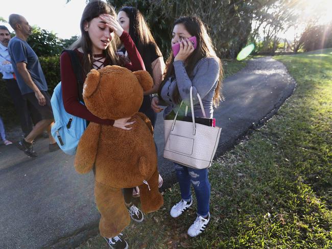 Distressed students wait to be picked up after a shooting at Marjory Stoneman Douglas High School in Parkland, Floria. Picture: AP Photo/Wilfredo Lee
