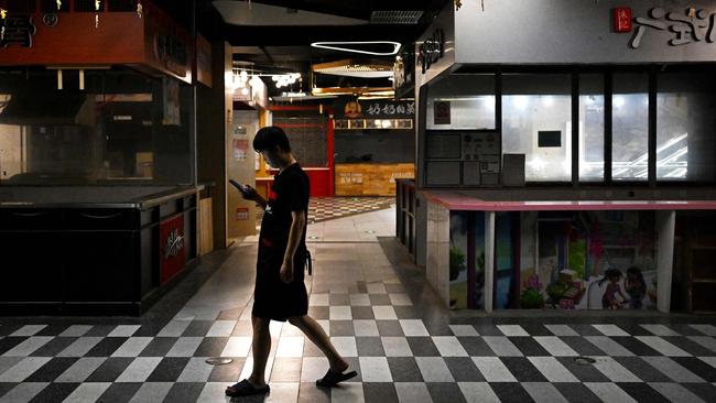 A man walks past closed food stalls at a mall in Beijing amid deepening concerns over the state of the world's second-largest economy. Picture: AFP