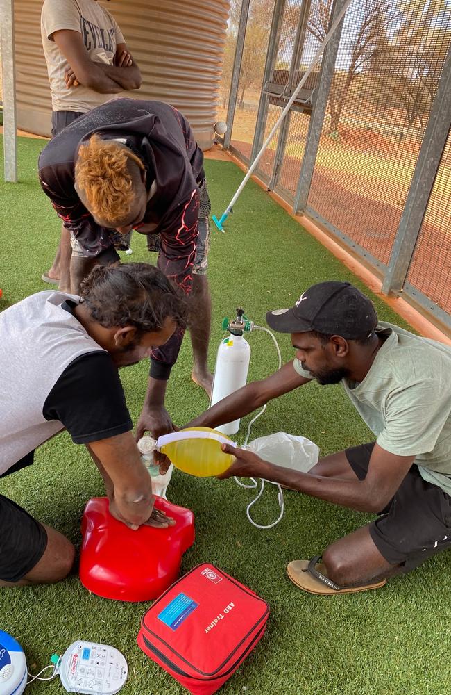 David Cooley, Clem Taylor and Christopher Dixon practice CPR as part of their lifeguard training in Mutitjulu. Picture: Supplied/ Central Land Council