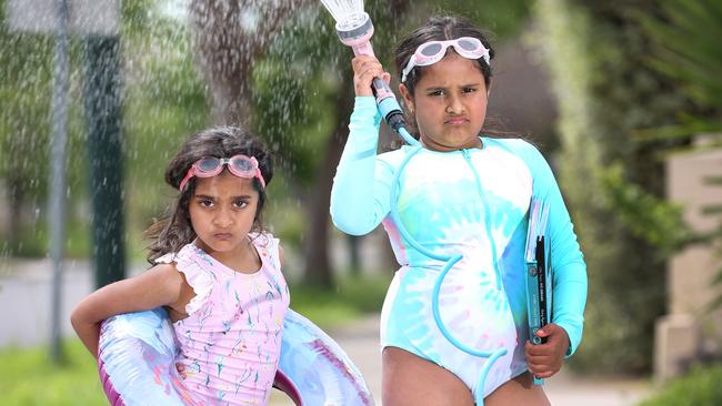 Sisters Mira, 5, and Vida, 8, have to make their own water fun. Picture: David Caird