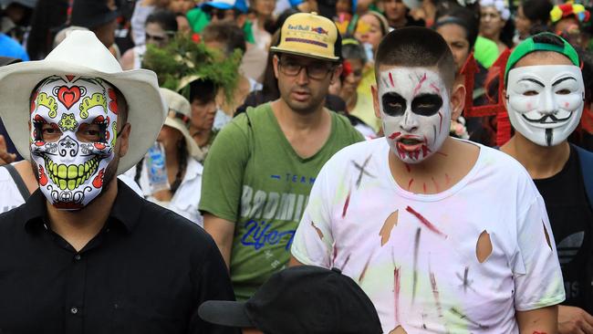 People wearing costumes attend a costume parade as part of Halloween celebrations in Medellin, Colombia on October 29, 2024. (Photo by JAIME SALDARRIAGA / AFP)