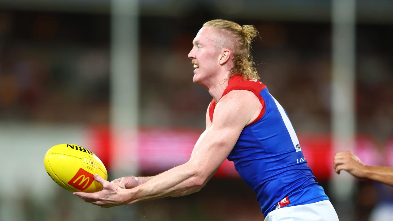 BRISBANE, AUSTRALIA - MARCH 24: Clayton Oliver of the Demons handballs during the round two AFL match between Brisbane Lions and Melbourne Demons at The Gabba, on March 24, 2023, in Brisbane, Australia. (Photo by Chris Hyde/Getty Images)