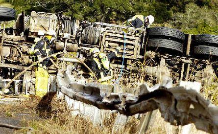 Crash scene: Fire and rescue personnel take control of the scene after a fuel tanker carrying petrol and diesel crashed on the Bruxner Highway south of Lismore on June 14, spilling 15,000 litres of fuel. . Picture: Jerad Williams