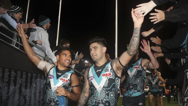 Jake Neade and Chad Wingard are all smiles as they head down to the rooms after the win. Picture Sarah Reed