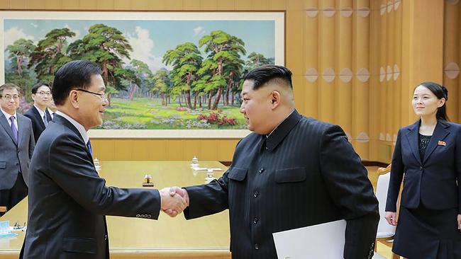 Kim Jong Un (R) shakes hands with South Korean chief envoy Chung Eui-yong (L). Picture: AFP.