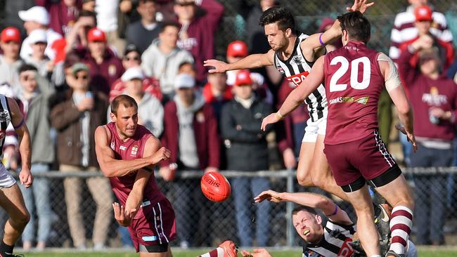 Prince Alfred OC’s Will Dalwood gets a handball away against Payneham Norwood Union in season’s division one grand final. Picture: Tom Huntley