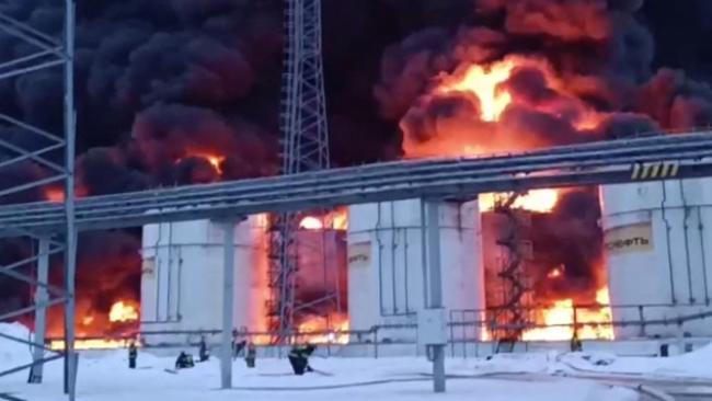 This video grab taken from footage released by Russian Emergency Ministry on January 19, 2024 shows rescuers working to extinguish a fire at an oil depot, following a Ukranian drone attack in Klintsy, Bryansk region. Picture: AFP