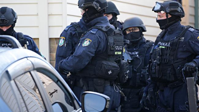 Armed police at the Punchbowl raid. Picture: Adam Yip