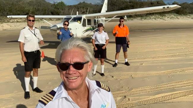 PILOT: Air Fraser owner and pilot Gerry Geltch, front, with some of the team.