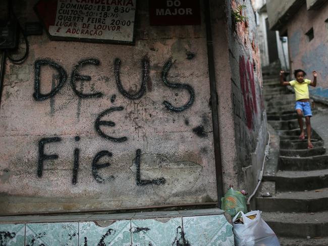 Graffiti reads 'God is Faithful' in the Mangueira 'favela' community in Rio