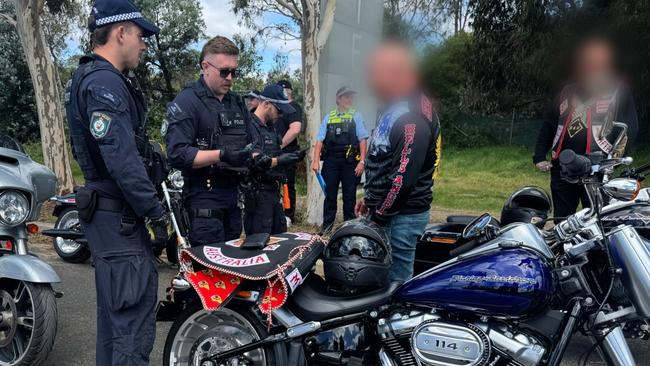 Raptor Squad officers speak to members of the Hells Angels.