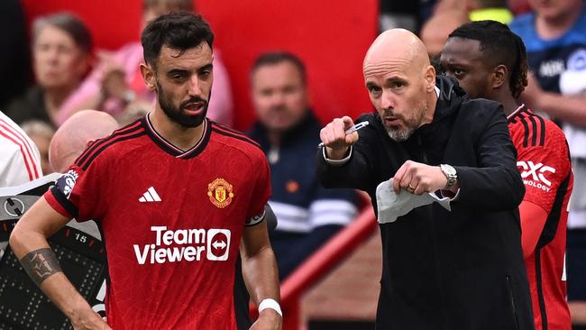 Manchester United's Dutch manager Erik ten Hag (R) gives instructions to Manchester United's Portuguese midfielder #08 Bruno Fernandes (L) during the English Premier League football match between Manchester United and Brighton and Hove Albion at Old Trafford in Manchester, north west England, on September 16, 2023. (Photo by Oli SCARFF / AFP) / RESTRICTED TO EDITORIAL USE. No use with unauthorized audio, video, data, fixture lists, club/league logos or 'live' services. Online in-match use limited to 120 images. An additional 40 images may be used in extra time. No video emulation. Social media in-match use limited to 120 images. An additional 40 images may be used in extra time. No use in betting publications, games or single club/league/player publications. /