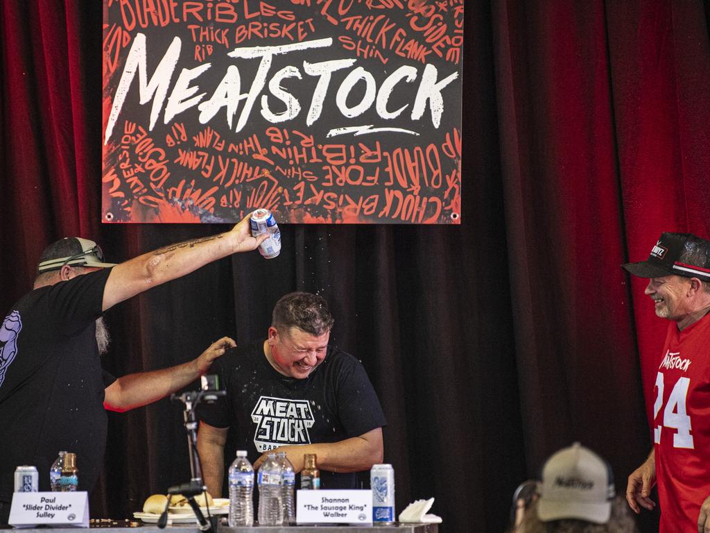 Paul Sulley (centre) celebrates his win in the Phat Boyz Slider Throwdown eating competition at Meatstock at Toowoomba Showgrounds, Sunday, March 10, 2024. Picture: Kevin Farmer