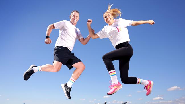 Tony Auden and Alissa Smith, from Channel 7, in their 2025 Bridge to Brisbane merchandise. Photo Steve Pohlner