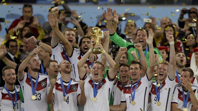 Bastian Schweinsteiger of Germany lifts the World Cup trophy with