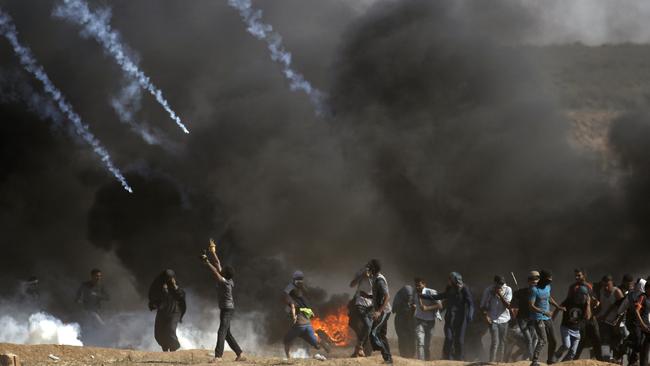 Tear gas is fired at protestors during clashes with Israeli forces near the border between the Gaza strip and Israel. Picture: AFP.