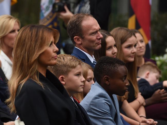 US First Lady Melania Trump sits with Jesse Barrett, husband of US Supreme Court nominee Amy Coney Barrett and their children, in the Rose Garden. Picture: AFP