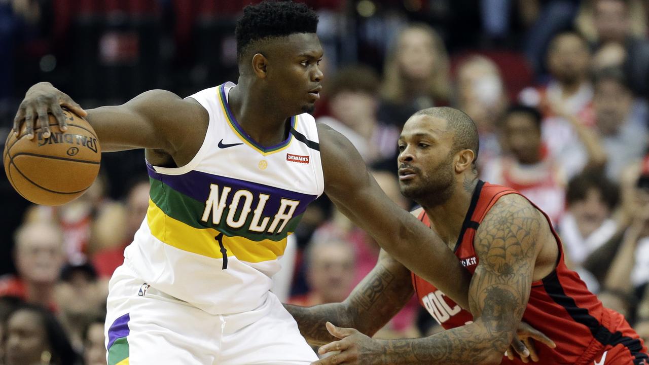 New Orleans Pelicans forward Zion Williamson (1) dribbles as Houston Rockets forward P.J. Tucker defends during the second half of an NBA basketball game, Sunday, Feb. 2, 2020, in Houston. (AP Photo/Eric Christian Smith)