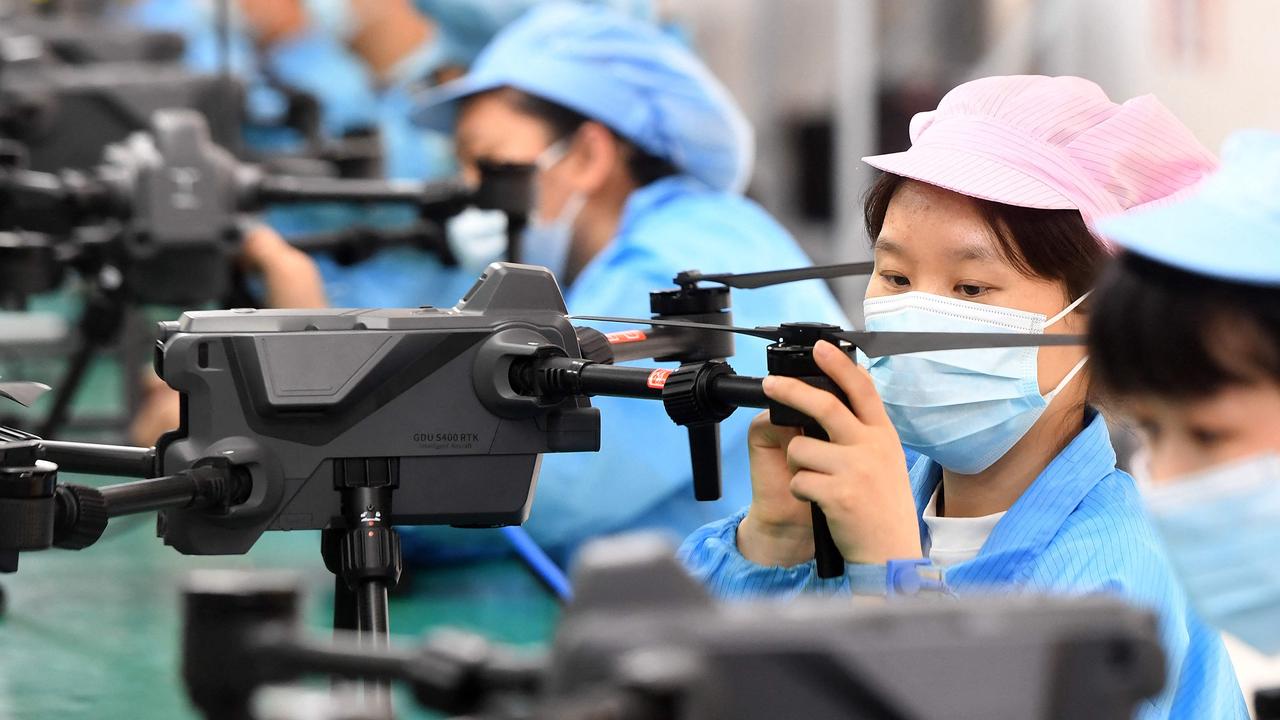 Workers producing drones at a factory in Wuhan, in China's central Hubei province. (Photo by AFP) / China OUT