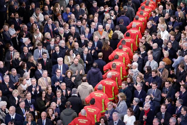 Firefighters walked through the congregation to thunderous applause