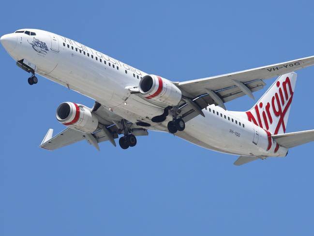 A Virgin Australia commercial passenger jet airplane comes into land at Cairns Airport. Picture: Brendan Radke