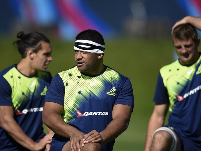 Australia's prop Scott Sio (2nd L) stretches during a team training session at the University of Bath.