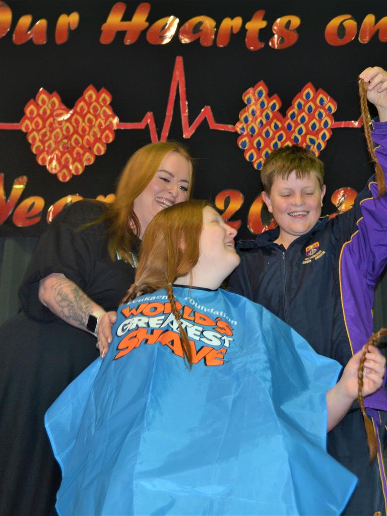 At the St Joseph's College 2023 World's Greatest Shave event is student Chelsee Kidd having her cut by her younger brother and hairdresser Rebecca Mortlock from the Hair Room on Russell. Picture: Rhylea Millar