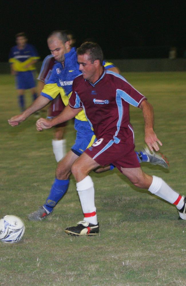 Coolum's Shane Clark battles with Kawana's Brad Lloyd for the ball. Photo: Brett Wortman