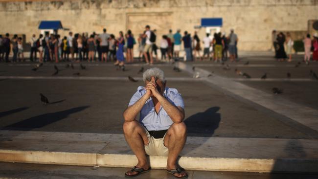 ATHENS, GREECE - JULY 13: A man sits alone with his thoughts as protesters gather outside the Greek parliament to demonstrate against austerity after an agreement for a third bailout with eurozone leaders on July 13, 2015 in Athens, Greece. The bailout is conditional on Greece passing agreed reforms in parliament by Wednesday which includes streamlining pensions and rasing more raise tax revenue. (Photo by Christopher Furlong/Getty Images)