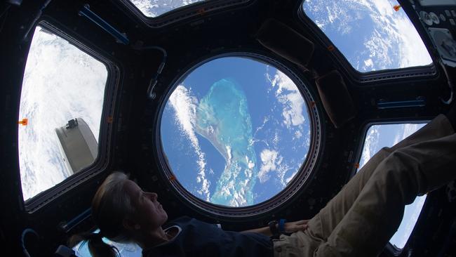 Dr Walker looks out of the international space station's cupola at the Caribbean view beneath during her first stint on board the ISS in November, 2010. Picture NASA