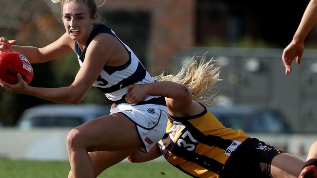 Amy McDonald of the Cats is tackled by Tayah Kelly of the Hawks during the VFLW match Hawthorn v Geelong played at Box Hill City Oval on Saturday 6th July, 2019.