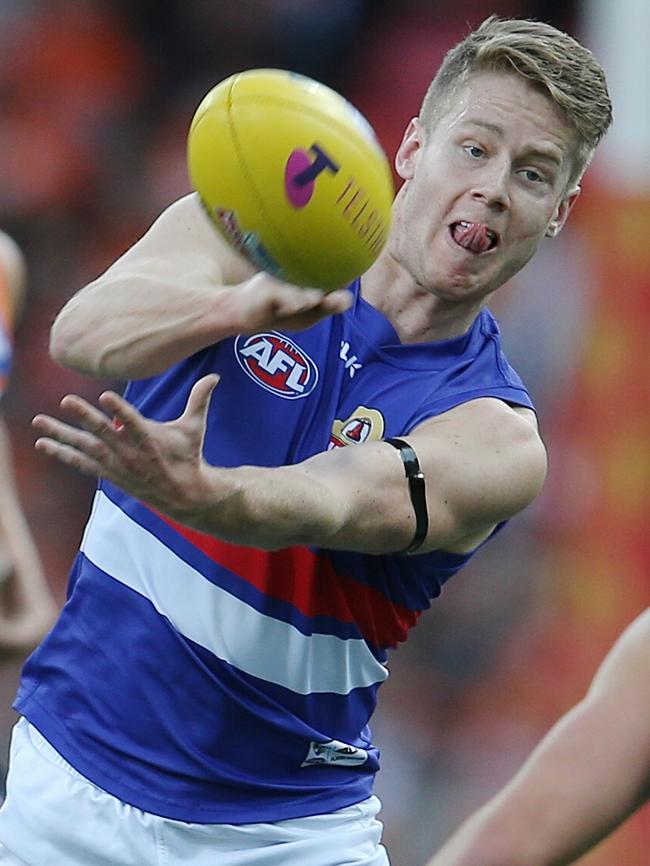 Lachie Hunter clears by hand. Picture: Michael Klein